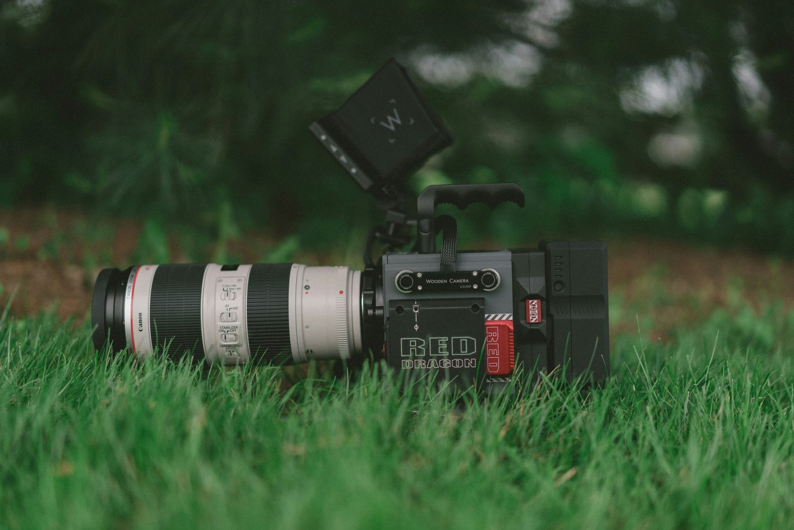 selective focus photography of professional video camera on grass field